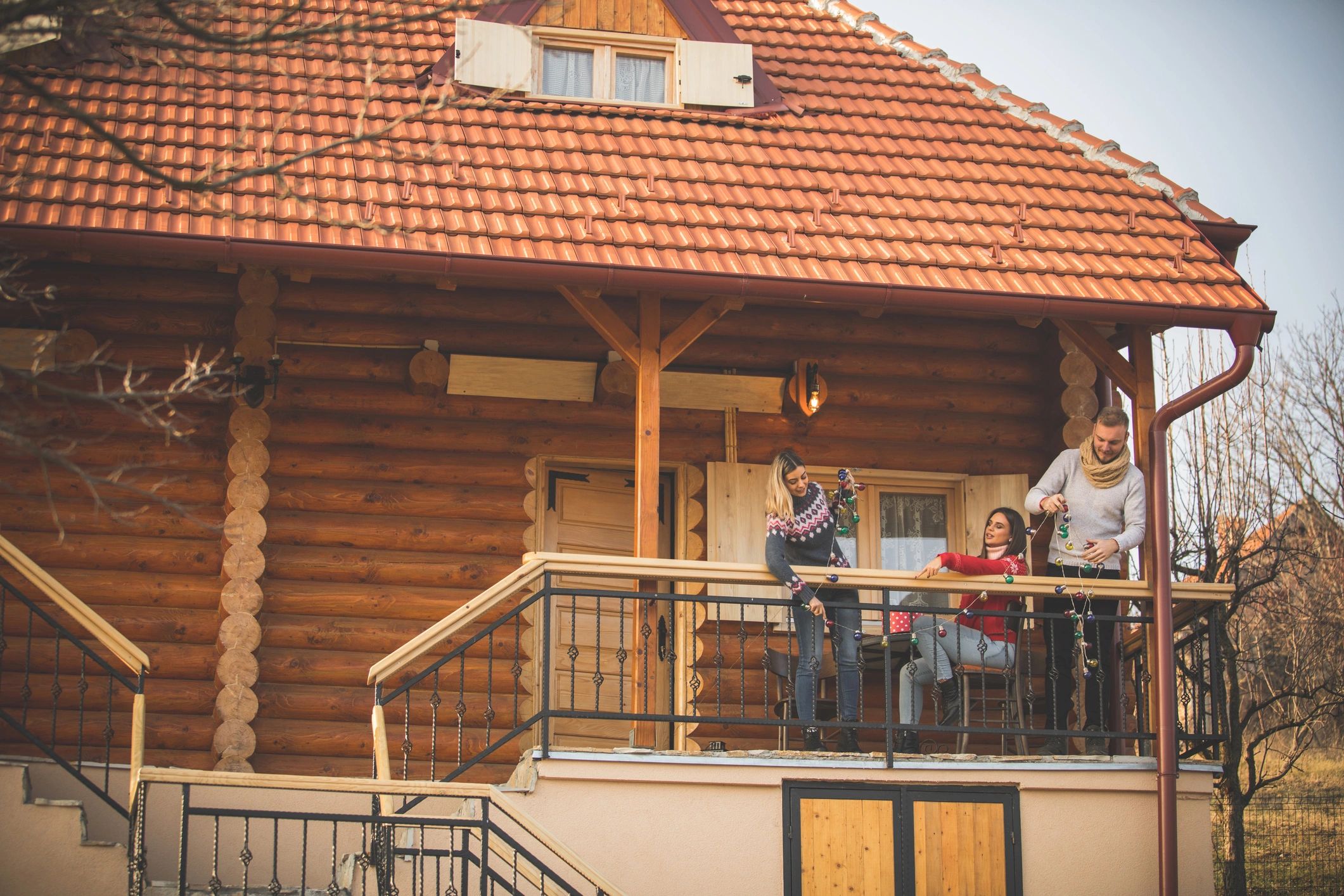 People gathered outside a wooden cabin retreat