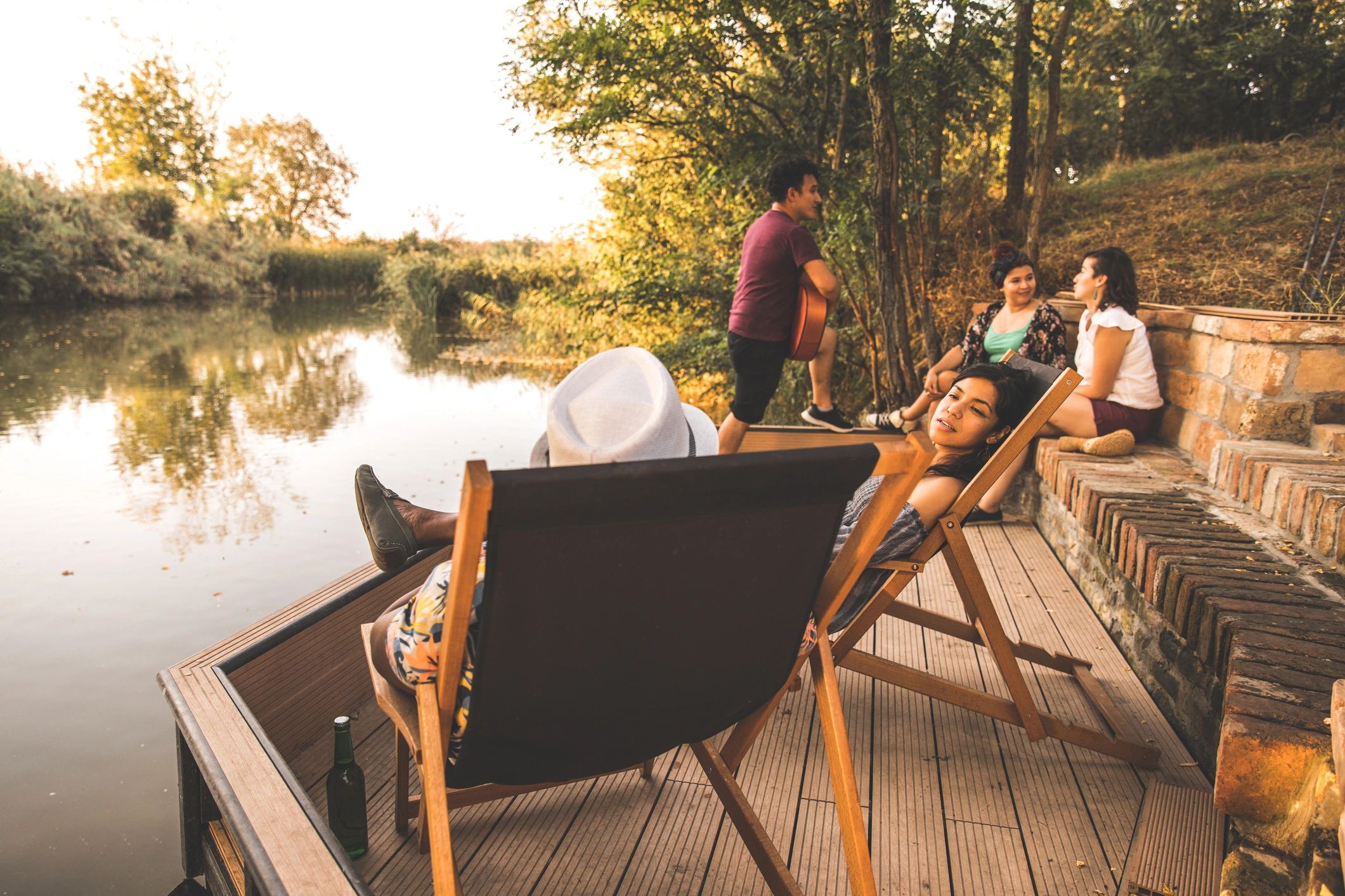 Group enjoying time together by a lake during an outdoor retreat
